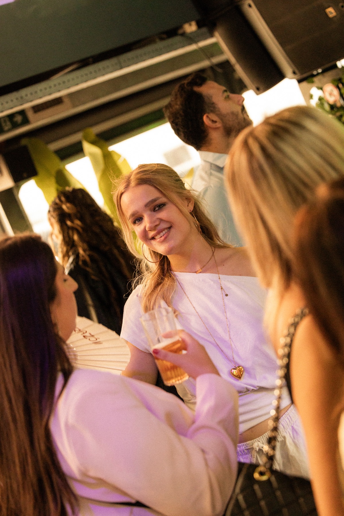 A smiling Sunset Cruise guest in a candid conversation